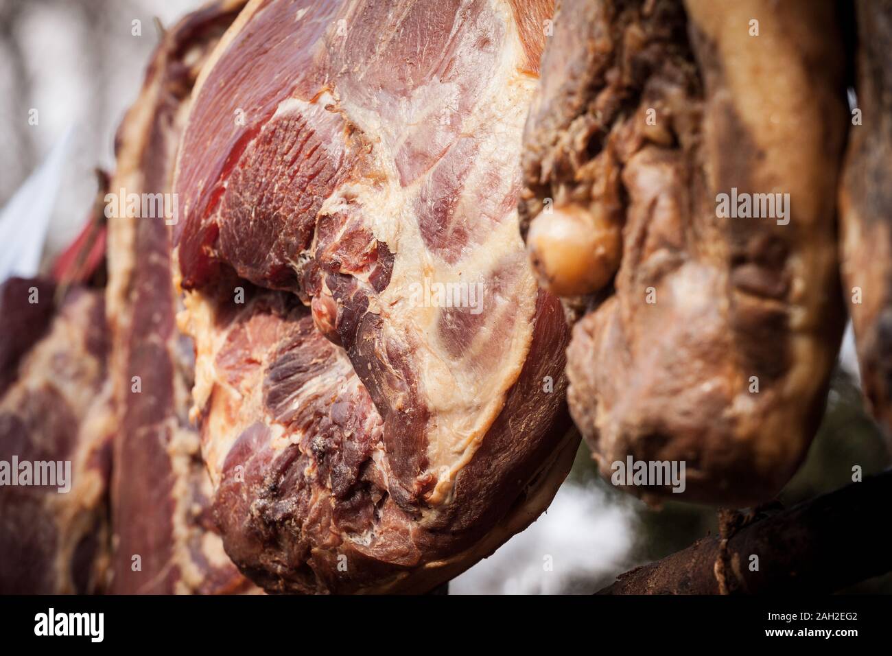 Serbian ham, called prsut, italian style, similar to prosciutto crudo, hanging in the countryside of Serbia. Prosciutto is a typical dry cured meat of Stock Photo