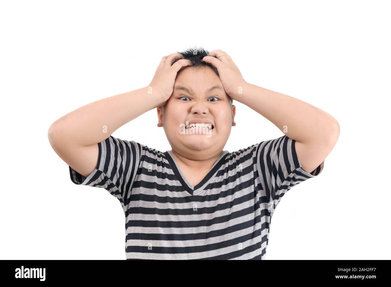 angry screaming obese fat boy in black and white shirt mad raising fist frustrated and furious. isolated on white background. Human emotions and facia Stock Photo