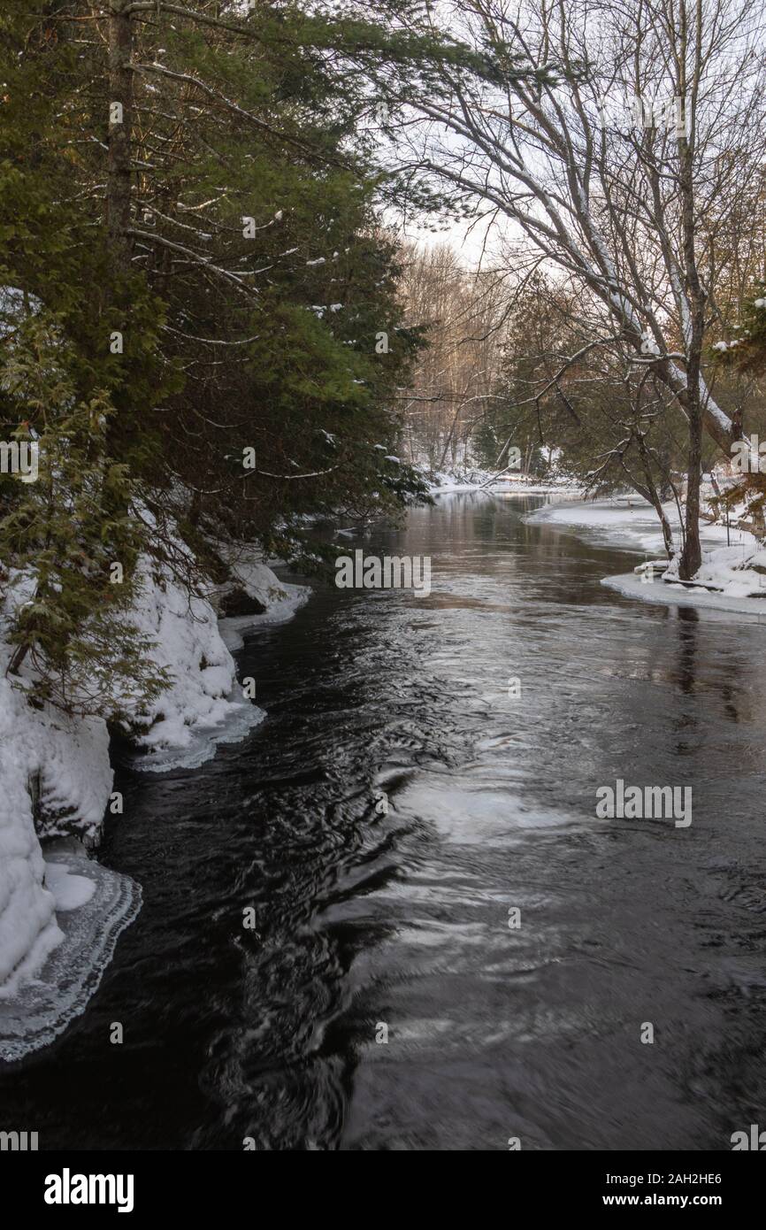 River flowing through forest snow hi-res stock photography and images ...