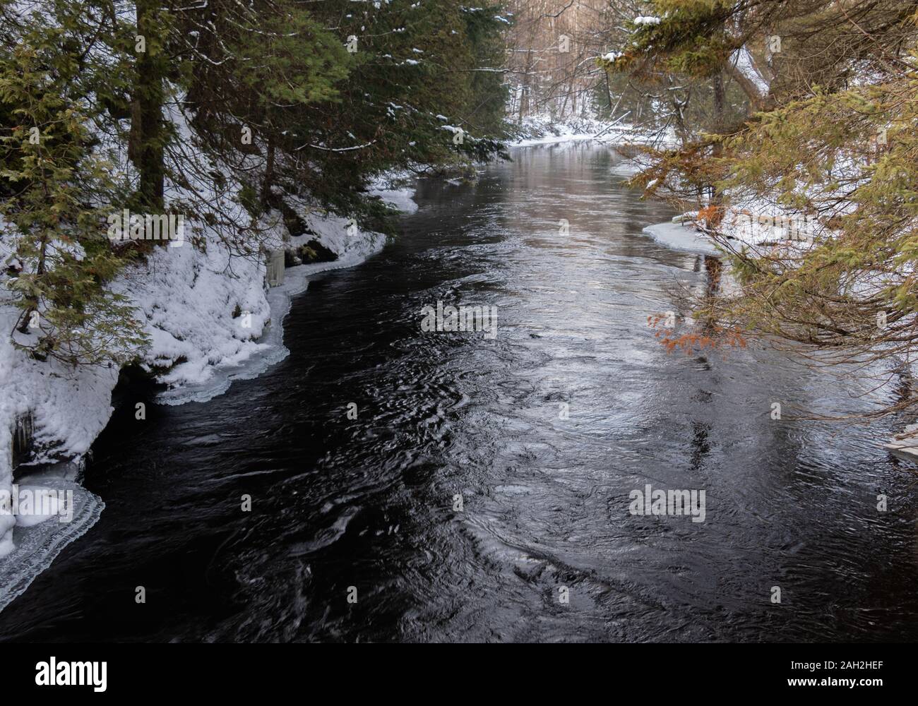 River flowing through forest snow hi-res stock photography and images ...