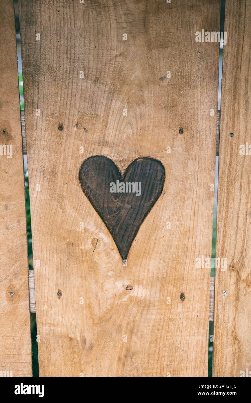 Carved heart on a wooden seat Stock Photo