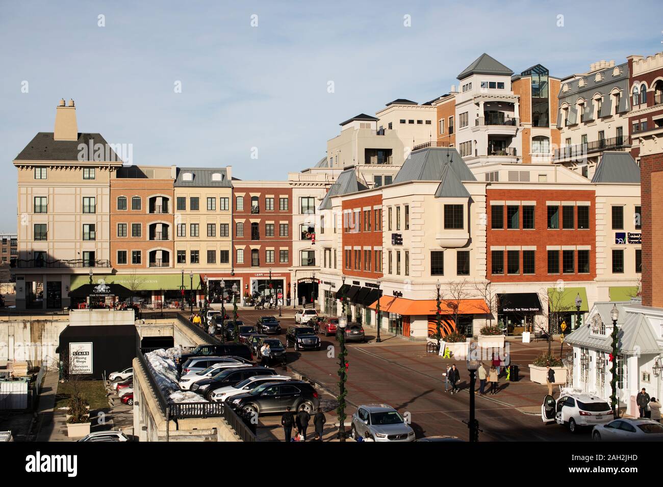 Pedestrians and shops at the Carmel City Center shopping plaza in downtown Carmel, Indiana, USA. Stock Photo