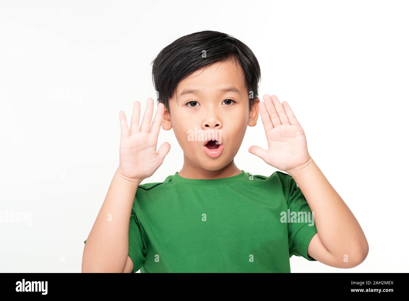 Cute asian schoolboy laughing and screaming isolated on white ...