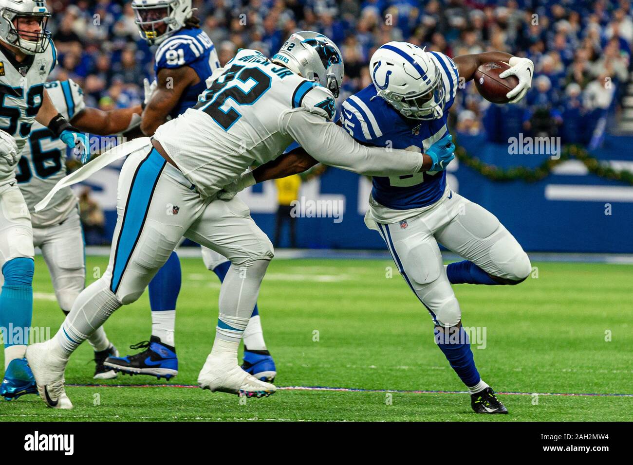 Indianapolis, Indiana, USA. 22nd Dec, 2019. Indianapolis Colts running back Marlon Mack (25) is hit by Carolina Panthers defensive tackle Vernon Butler (92) in the first half of the game between the Carolina Panthers and the Indianapolis Colts at Lucas Oil Stadium, Indianapolis, Indiana. Credit: Scott Stuart/ZUMA Wire/Alamy Live News Stock Photo