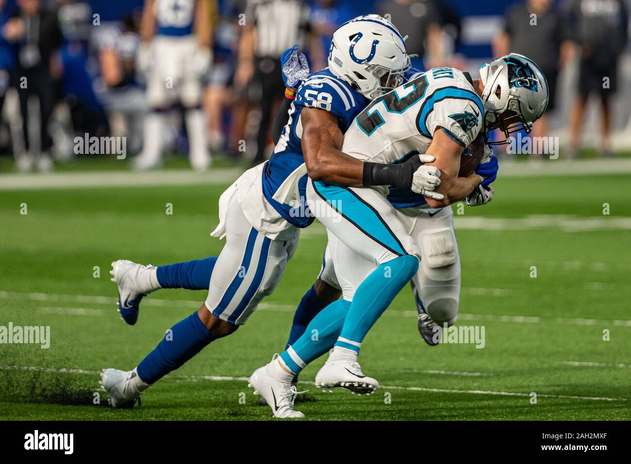 Indianapolis, Indiana, USA. 22nd Dec, 2019. Carolina Panthers running back Christian McCaffrey (22) is tackled by Indianapolis Colts inside linebacker Bobby Okereke (58) in the first half of the game between the Carolina Panthers and the Indianapolis Colts at Lucas Oil Stadium, Indianapolis, Indiana. Credit: Scott Stuart/ZUMA Wire/Alamy Live News Stock Photo