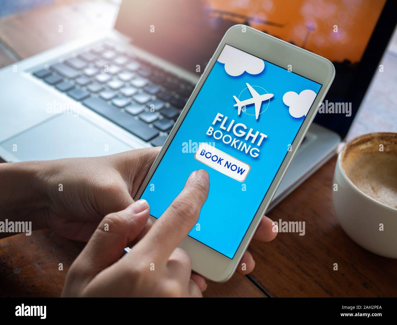 Flight booking online with smartphone. Finger touching on mobile phone