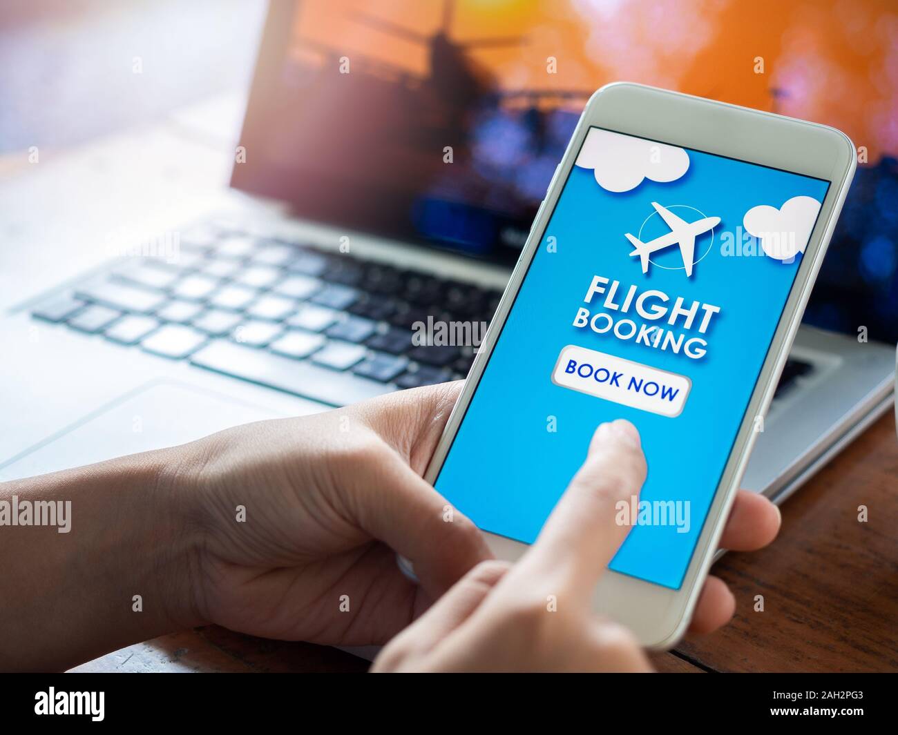 Flight booking online with smartphone. Finger touching on mobile phone