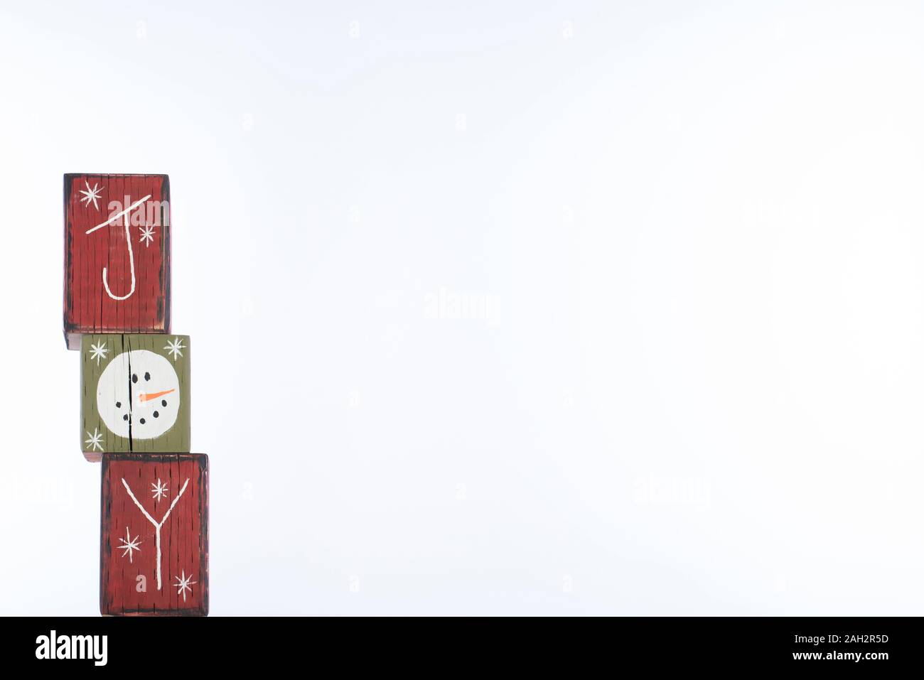 Painted red and green wooden blocks vertically spelling the word "joy