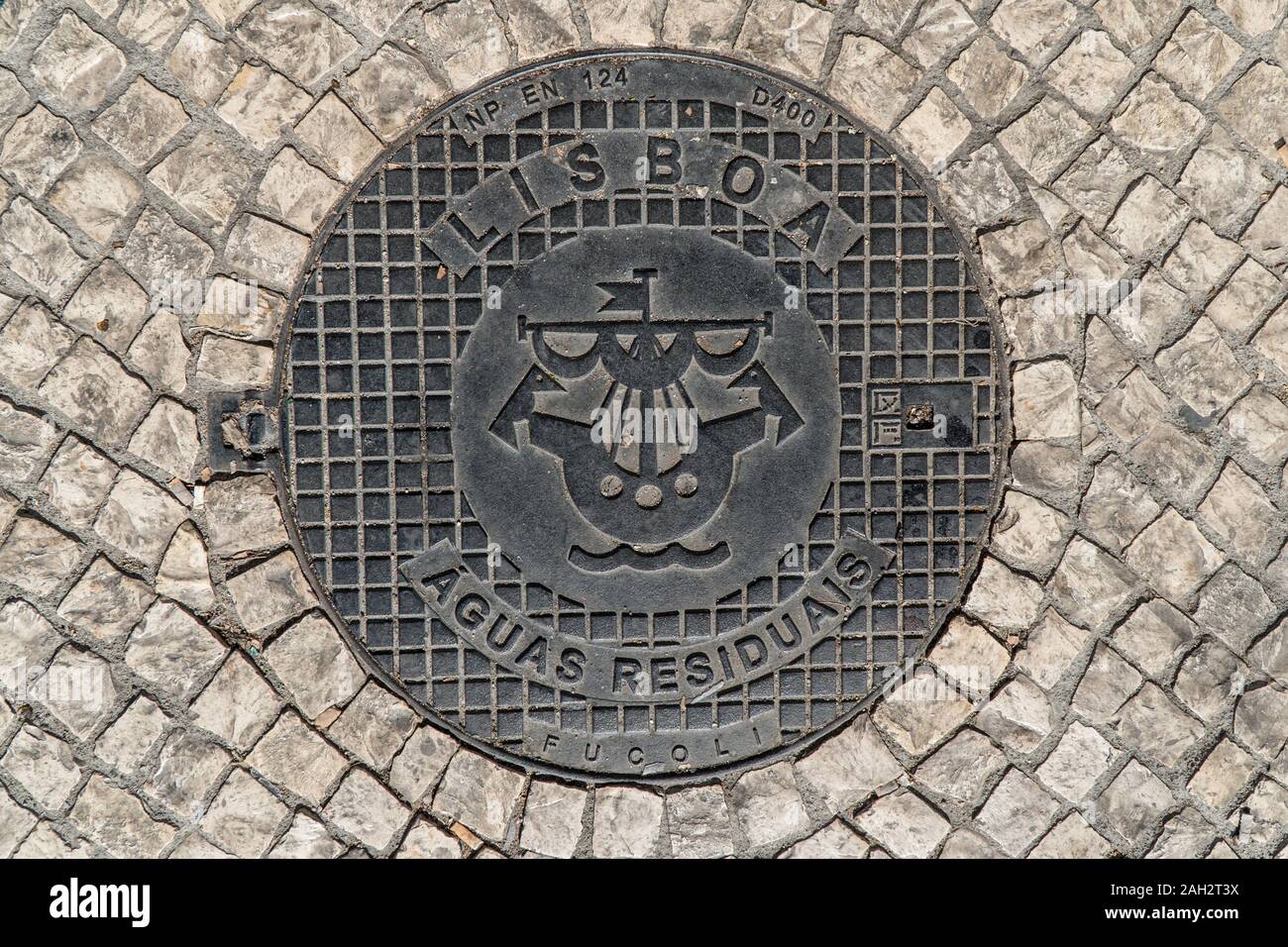 Lisbon, Portugal - october 10, 2017: Black metal hatch  for residual waters in a stone pavement in Lisbon,Portugal Stock Photo