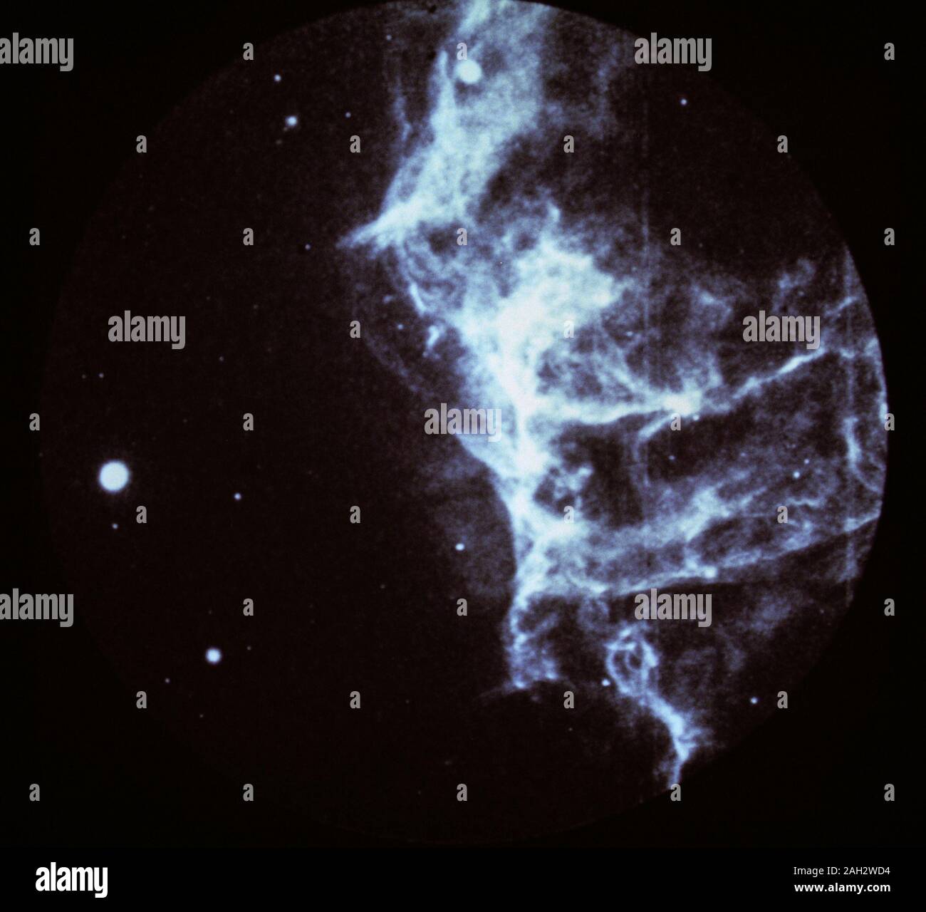 Pictured is a portion of the huge Cygnus loop, an array of interstellar gas clouds that have been blasted by a 900,000 mile per hour shock wave from a prehistoric stellar explosion, which occurred about 20,000 years ago, known as supernova. With ultraviolet and x-rays, astronomers can see emissions from extremely hot gases, intense magnetic fields, and other high-energy phenomena that more faintly appear in visible and infrared light or in radio waves that are crucial to deepening the understanding of the universe. Stock Photo