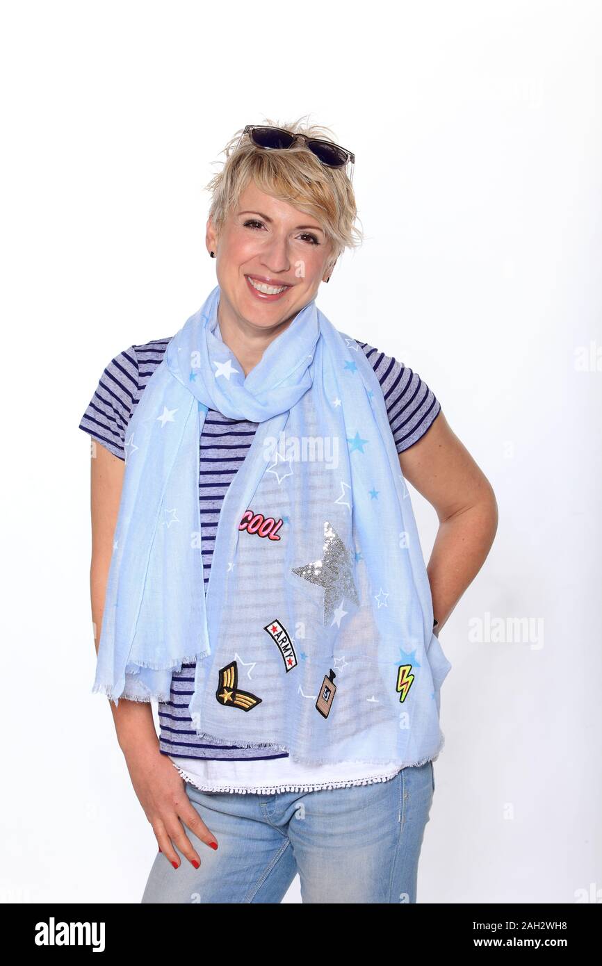 Smiling blond woman with a neck scarf posing  against white background, portrait. Stock Photo