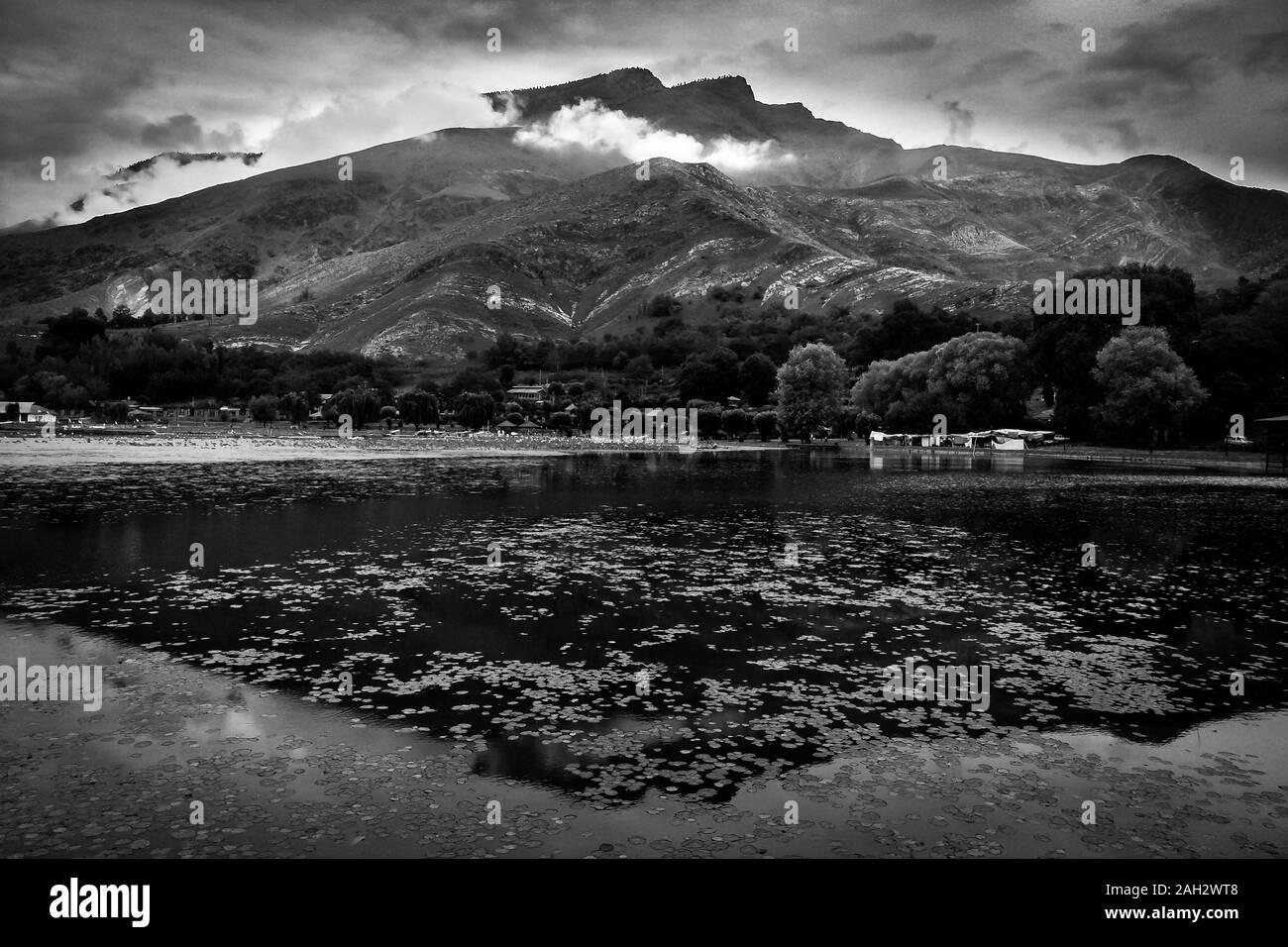 Dramatic black and white view of Manasbal lake with a hill in the backdrop Stock Photo