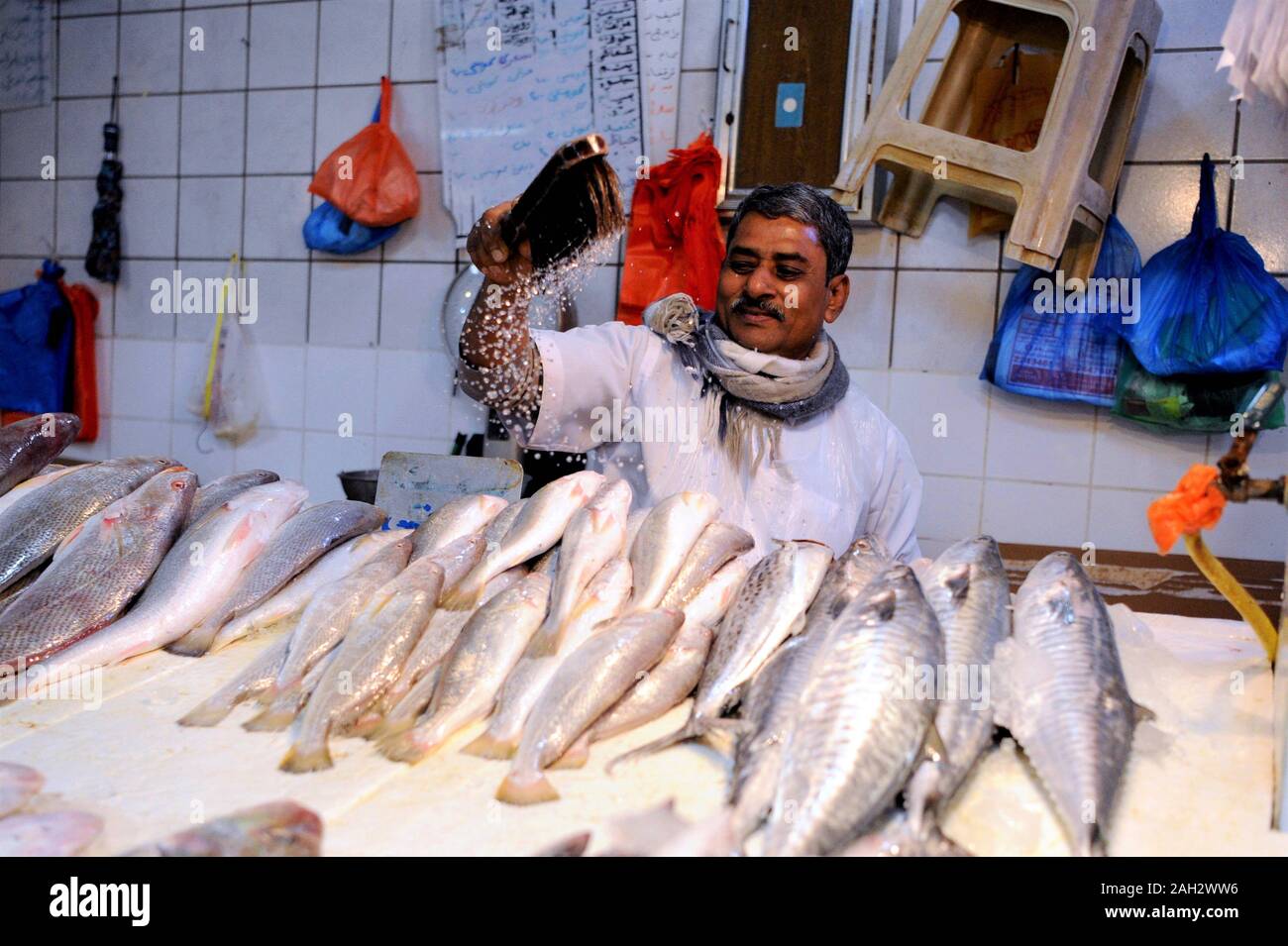 Kuwait City, Kuwait. 23rd Dec, 2019. A fish vendor waits for customers
