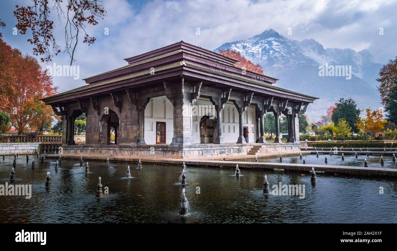 Mughal Heritage Building with snoe covered Zabarwan Mountains in the background during Autumn in Shalimar Bagh Mughal Garden of Kashmir Stock Photo
