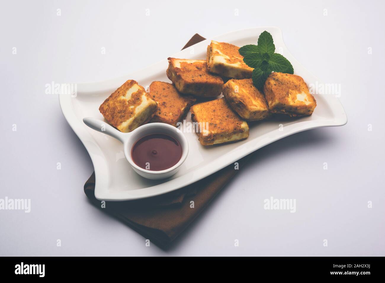 Amritsari Paneer Tikka made using cottage cheese cubes dipped in a