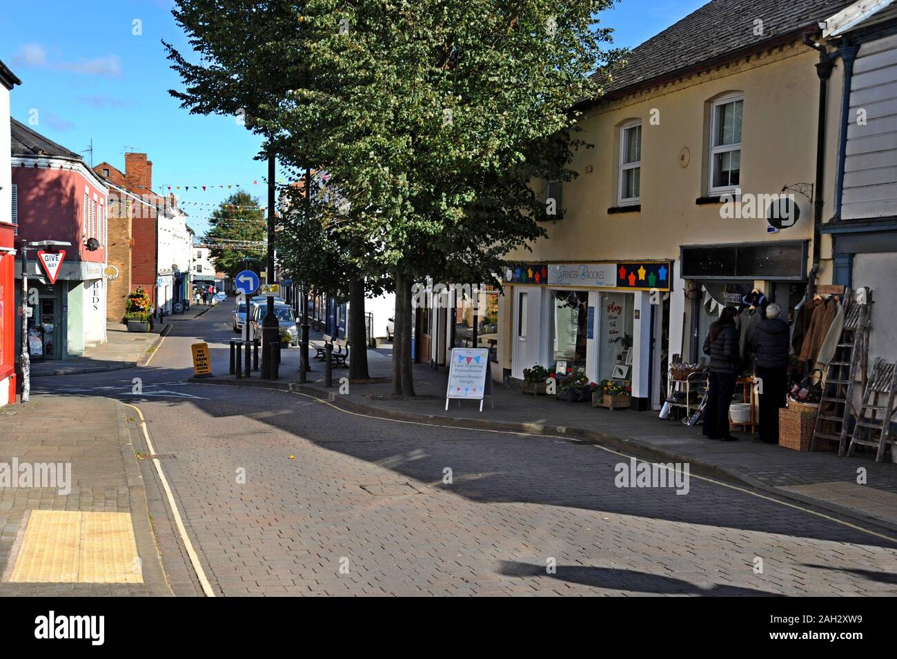 A view down West Street, Leominster, Herefordshire, with people browsing outside an antiques centre Stock Photo