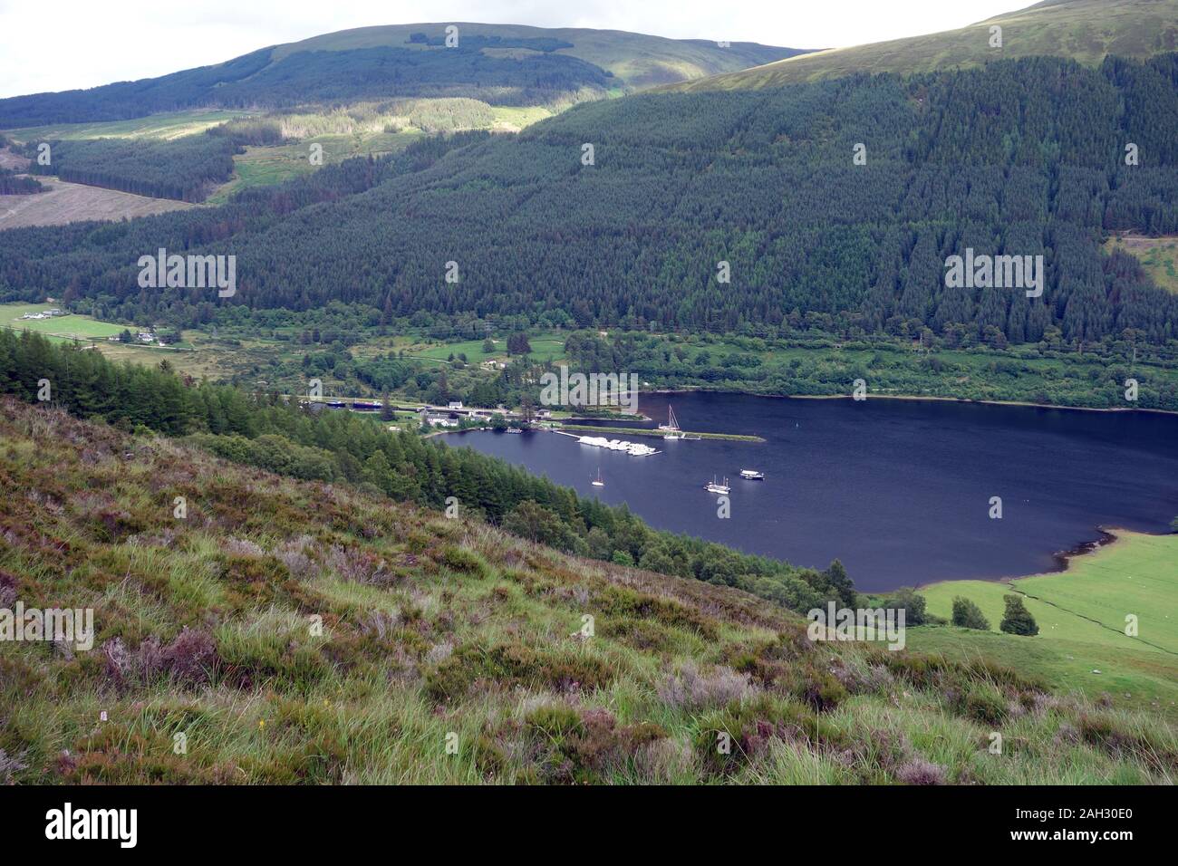 Boats Moored up at Laggan Locks on Ceann Loch from the Path to the Scottish Mountain Corbett Ben Tee in the Great Glen, Scottish Highlands, Scotland. Stock Photo