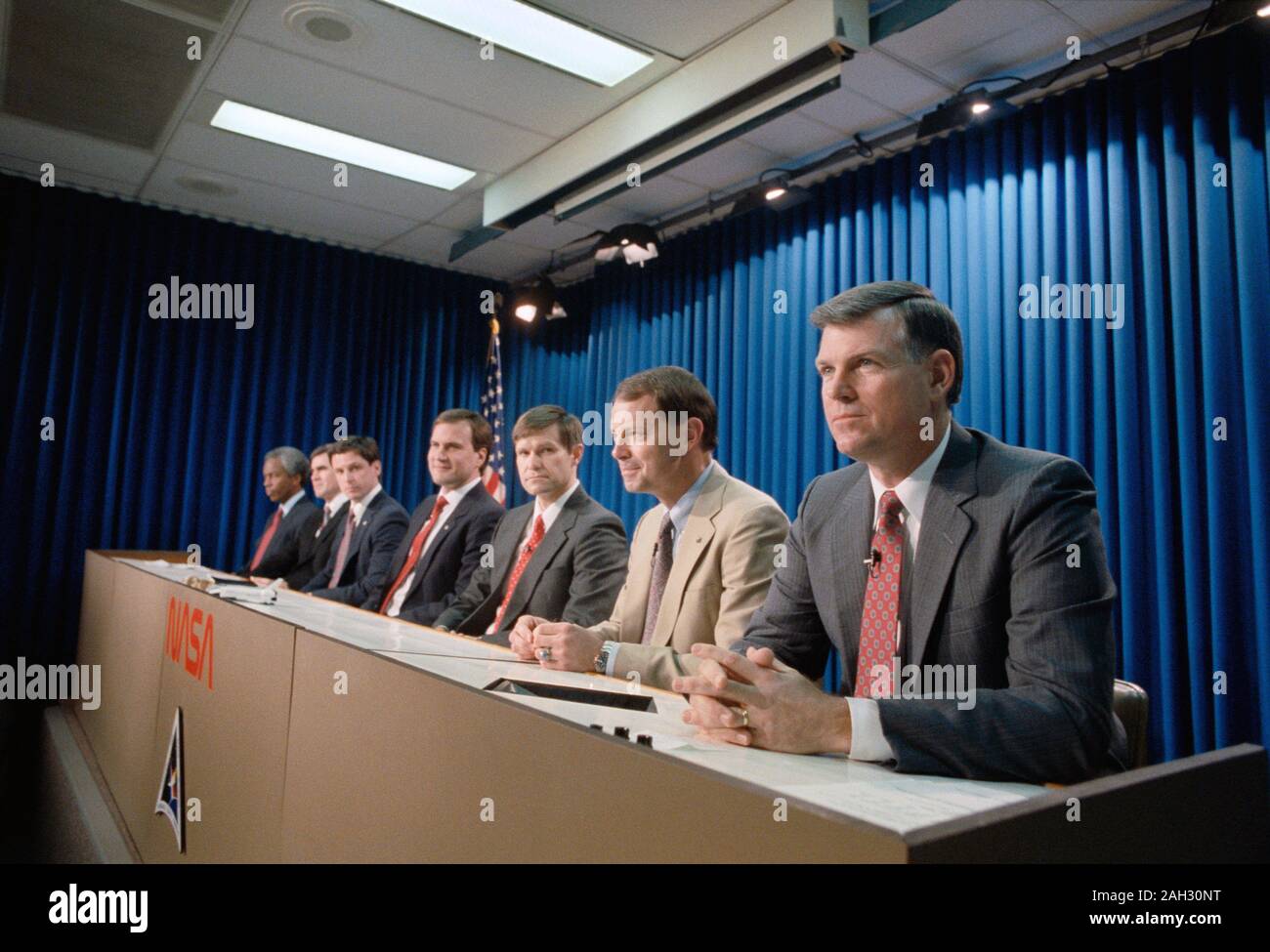 (23 Jan 1991) --- Astronaut Michael L. Coats,  mission commander, listens attentively as a news media representative (out of frame) queries the STS-39 crewmembers during a pre-flight press briefing. The others, pictured left to right, are Astronauts Guion (Guy) S. Bluford, C. Lacy Veach, Gregory J. Harbaugh, Richard J. Hieb, Donald R. McMonagle and L. Blaine Hammond Jr. Stock Photo