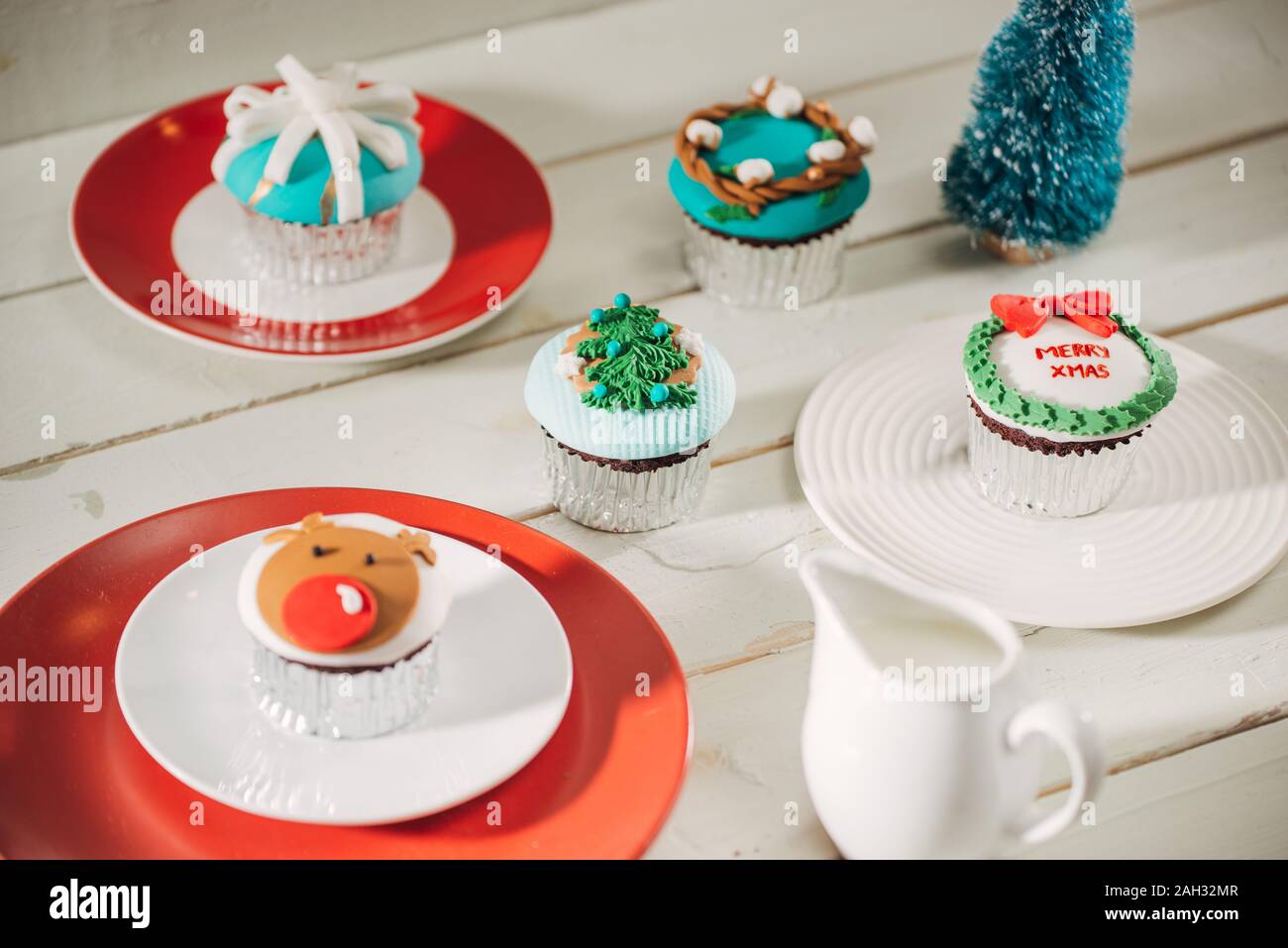 Christmas theme cupcakes in traditional red green colors and candy elements from overhead Stock Photo