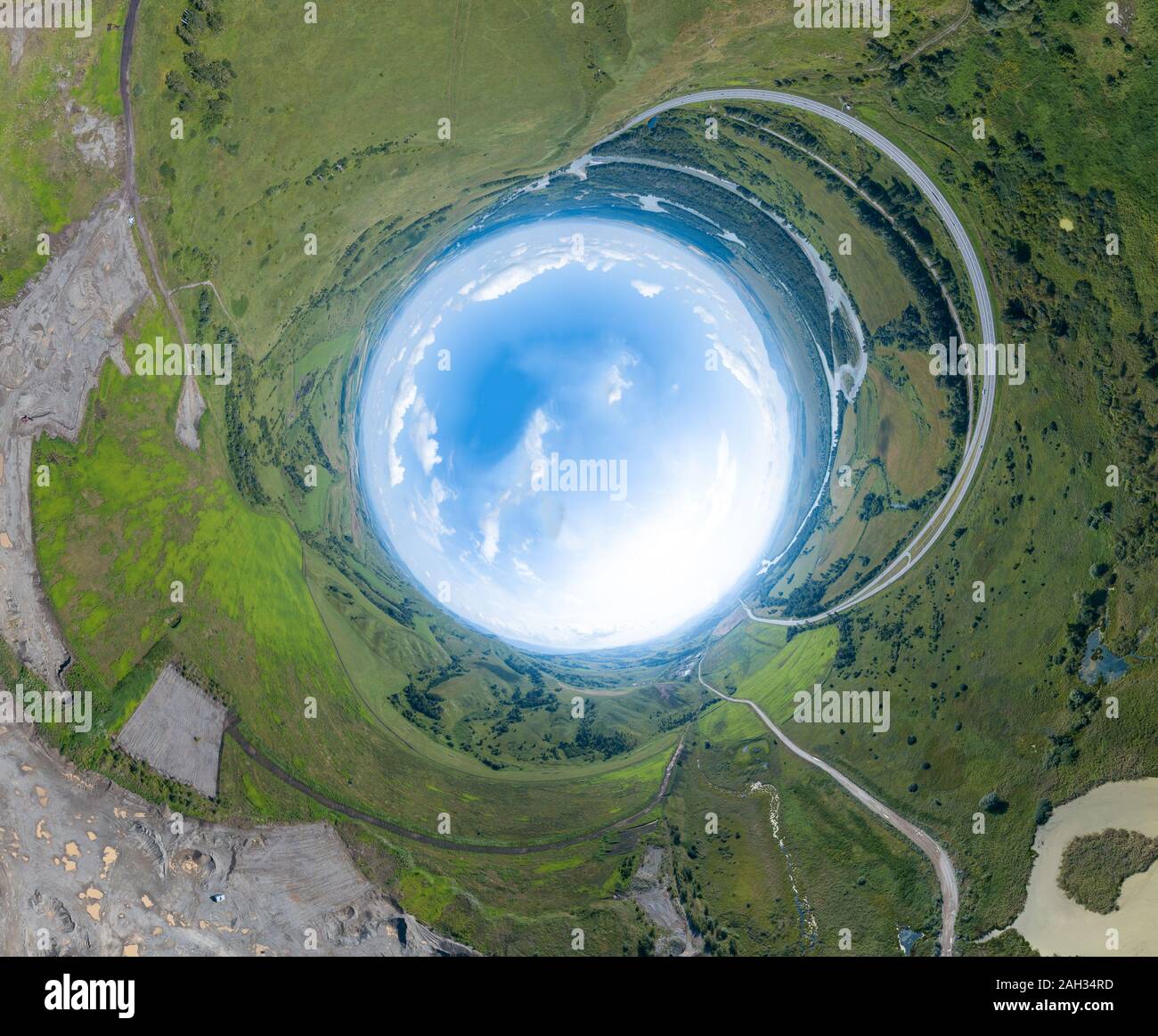 360 degree panoramic image of an abstract world turned inside out with green meadows around an 