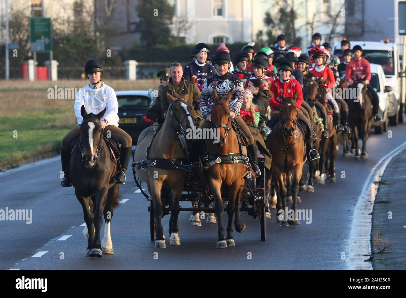 Blackheath, London, UK. 24th December, 2019. The King's Troop Royal Horse Artillery has donned Christmas outfits for the traditional Christmas eve ride from its base in Woolwich to Morden College in Blackheath. Credit: Rob Powell/Alamy Live News Stock Photo