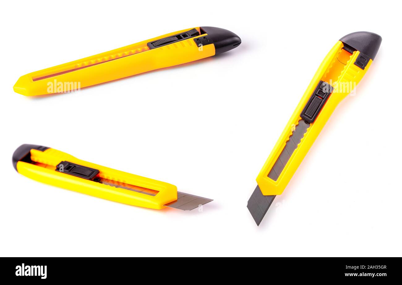The yellow stationery knife isolated on white background Stock Photo