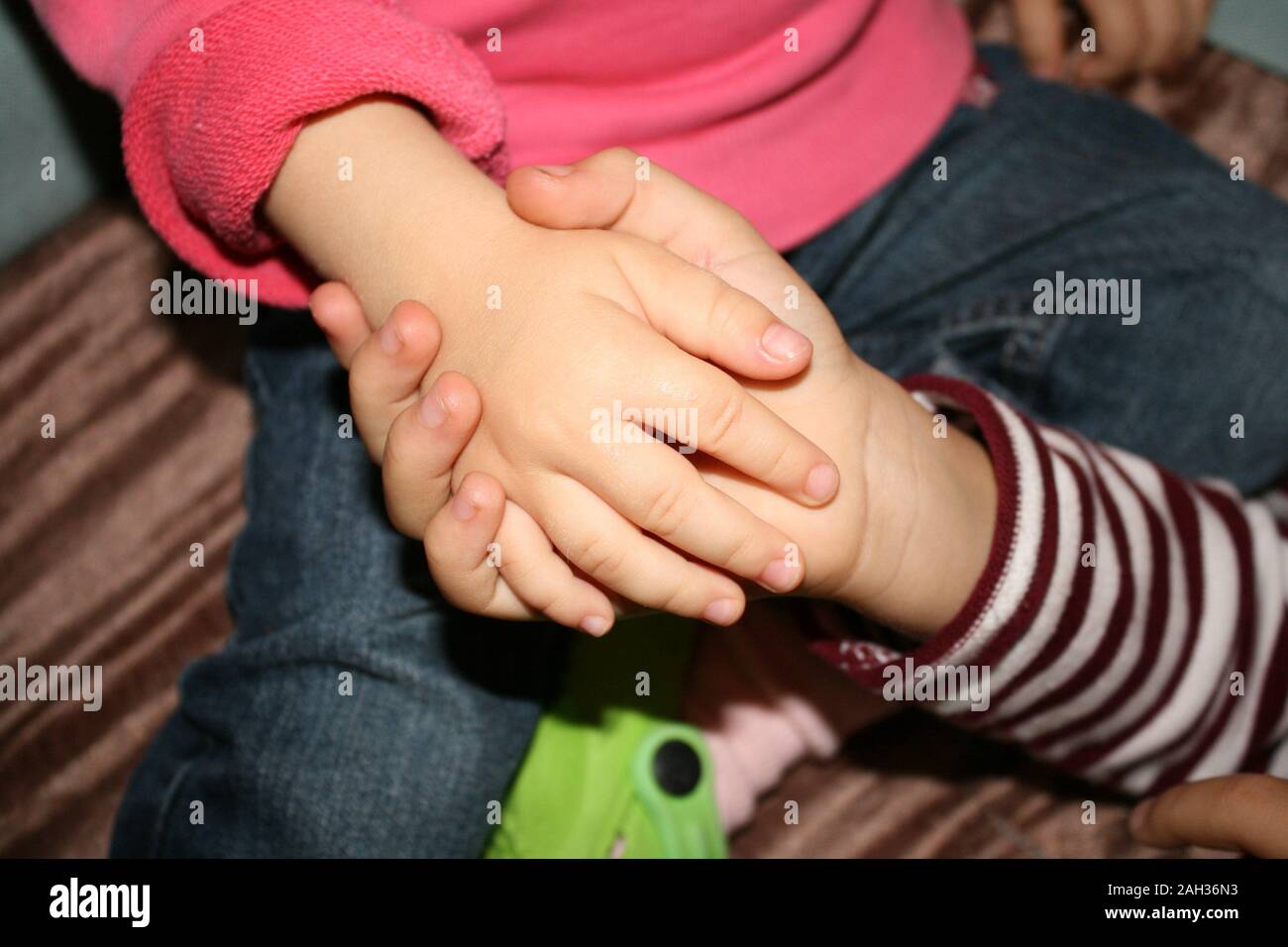 hands as a symbol of childhood friendship, mutual support and love Stock Photo