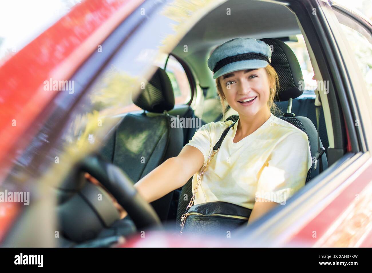 Happy woman driver behind the wheel red car Stock Photo Alamy