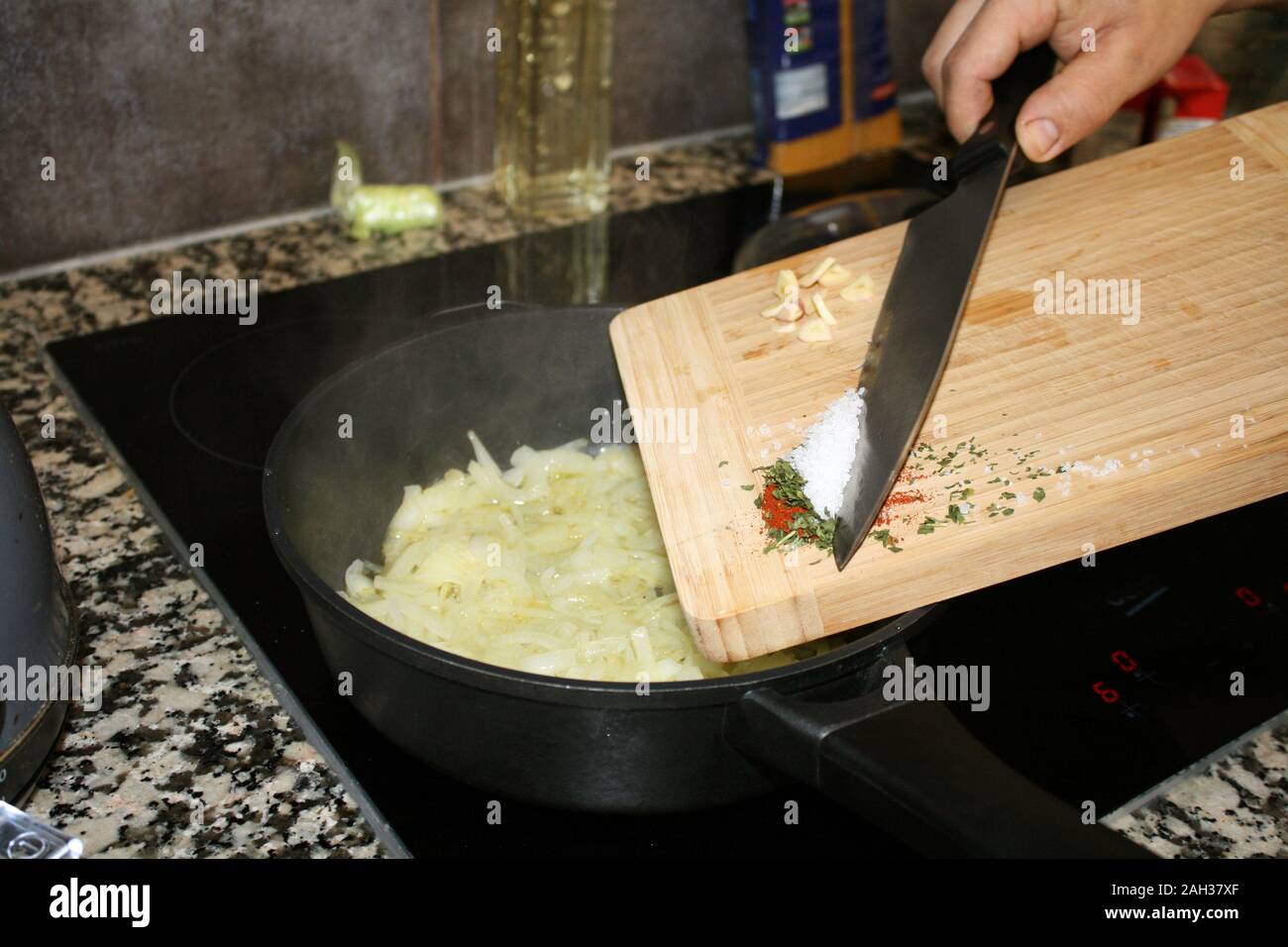 The process of frying onions and pouring spices Stock Photo Alamy