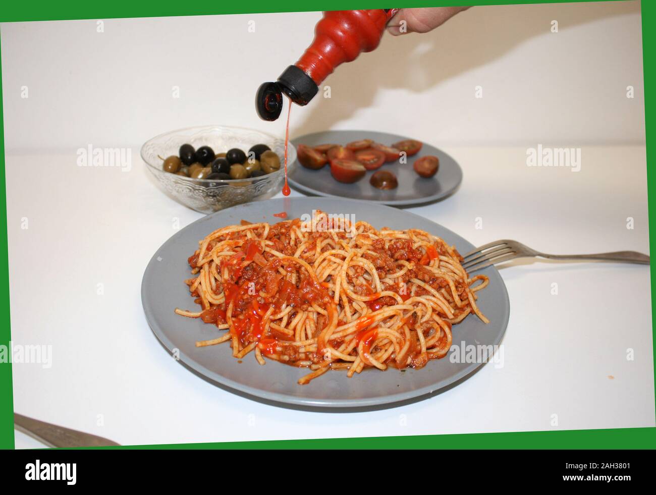 Spaghetti with bolognese sauce poured piri piri and olives with