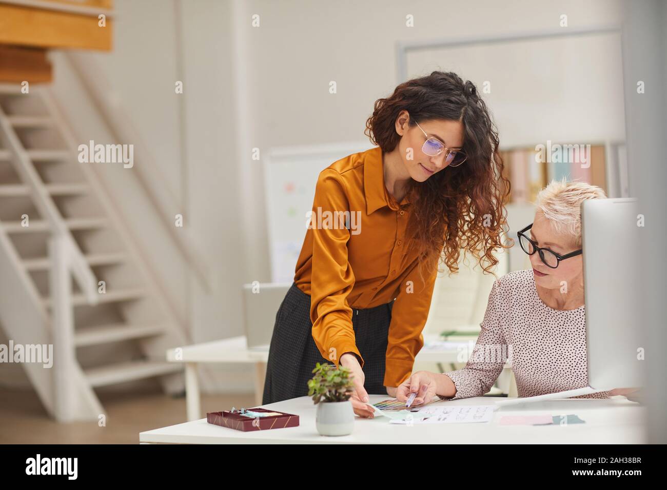 Horizontal shot of two female clothes designers working together on new fashion collection Stock Photo