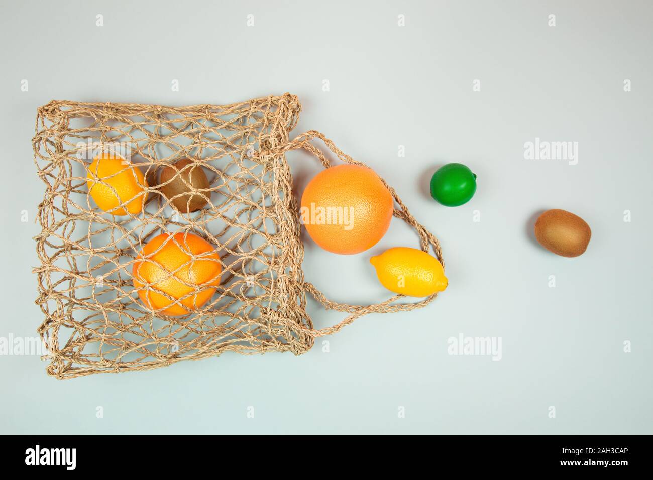 Fruits on textile bag. Trendy green background. Zero waste concept. Flat lay style. Stock Photo