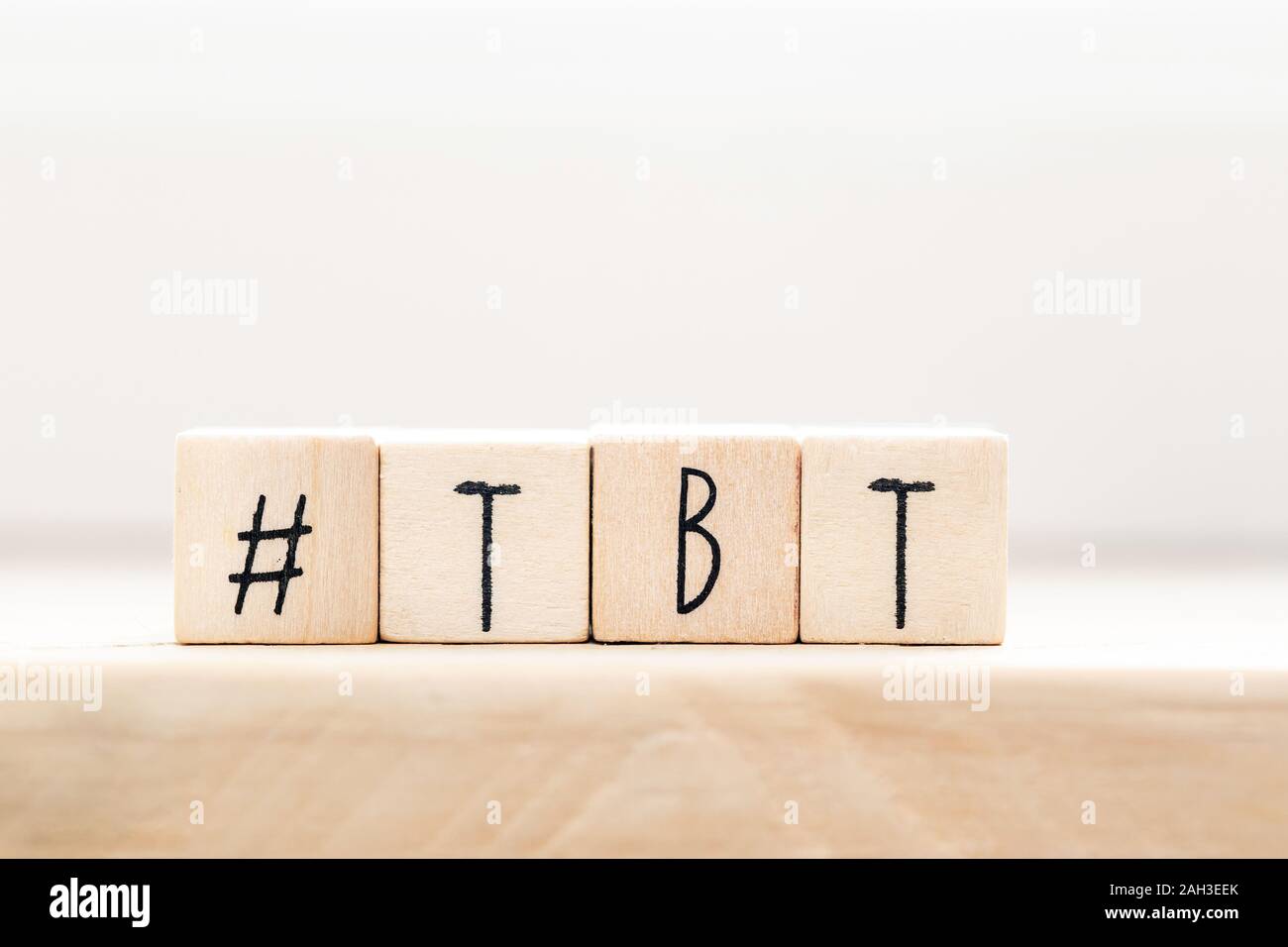 Wooden cubes with Hashtag tbt, meaning Throwback Thursday near white background social media concept Stock Photo