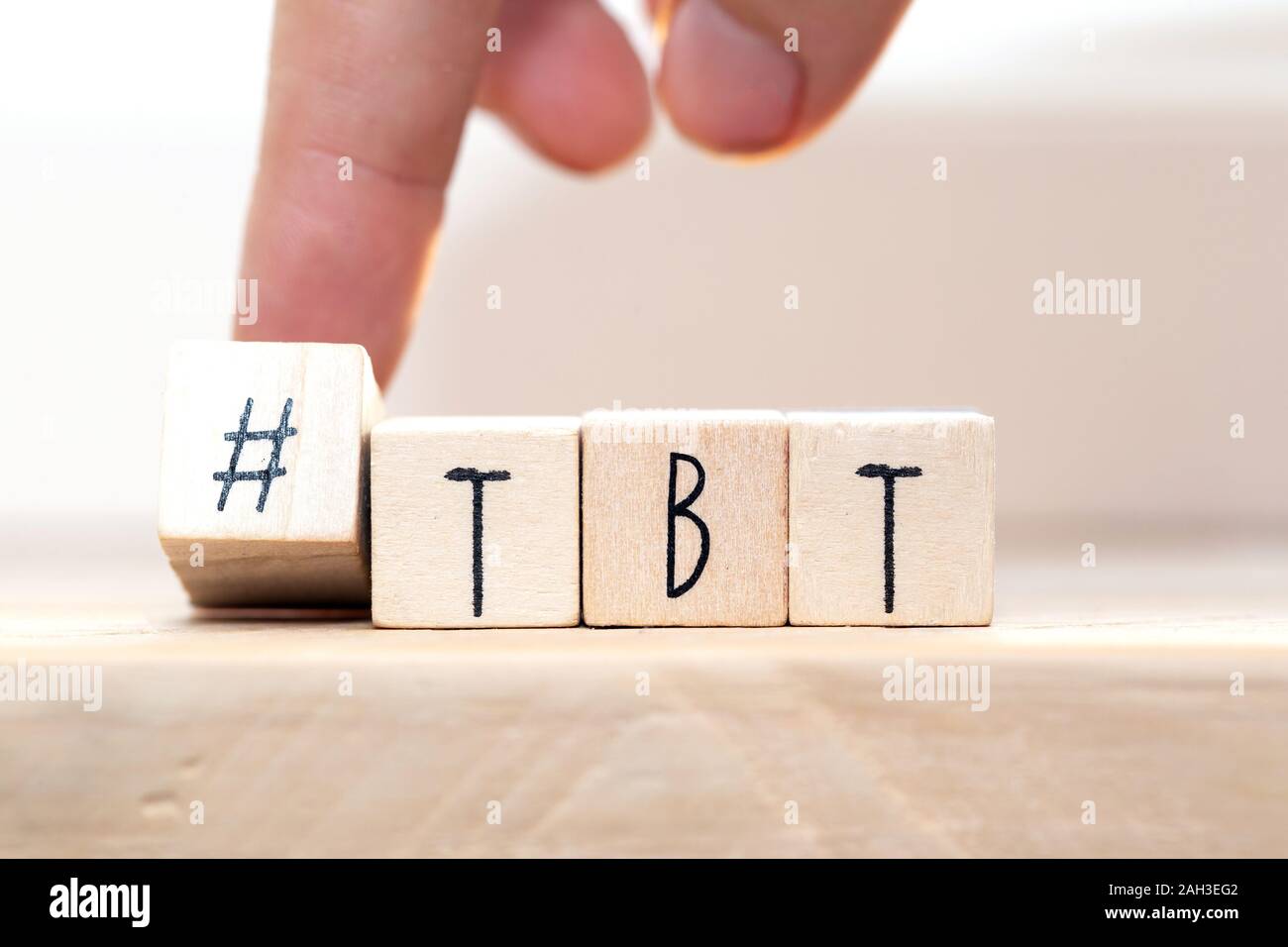 Wooden cubes with Hashtag tbt, meaning Throwback Thursday near white background social media concept Stock Photo