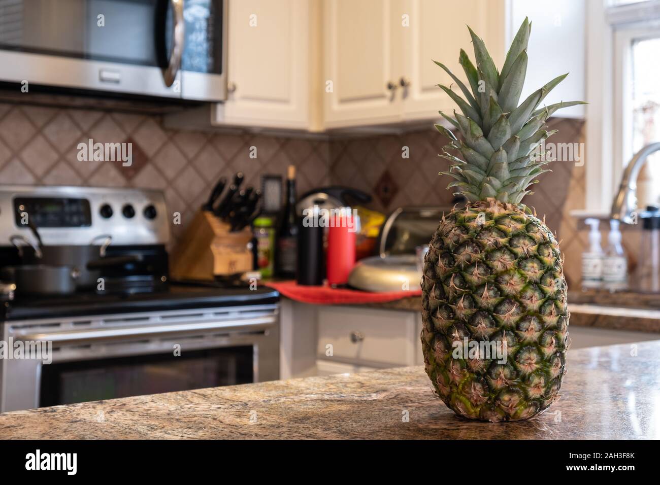Interior of a kitchen with a pineapple on the foreground Stock Photo ...