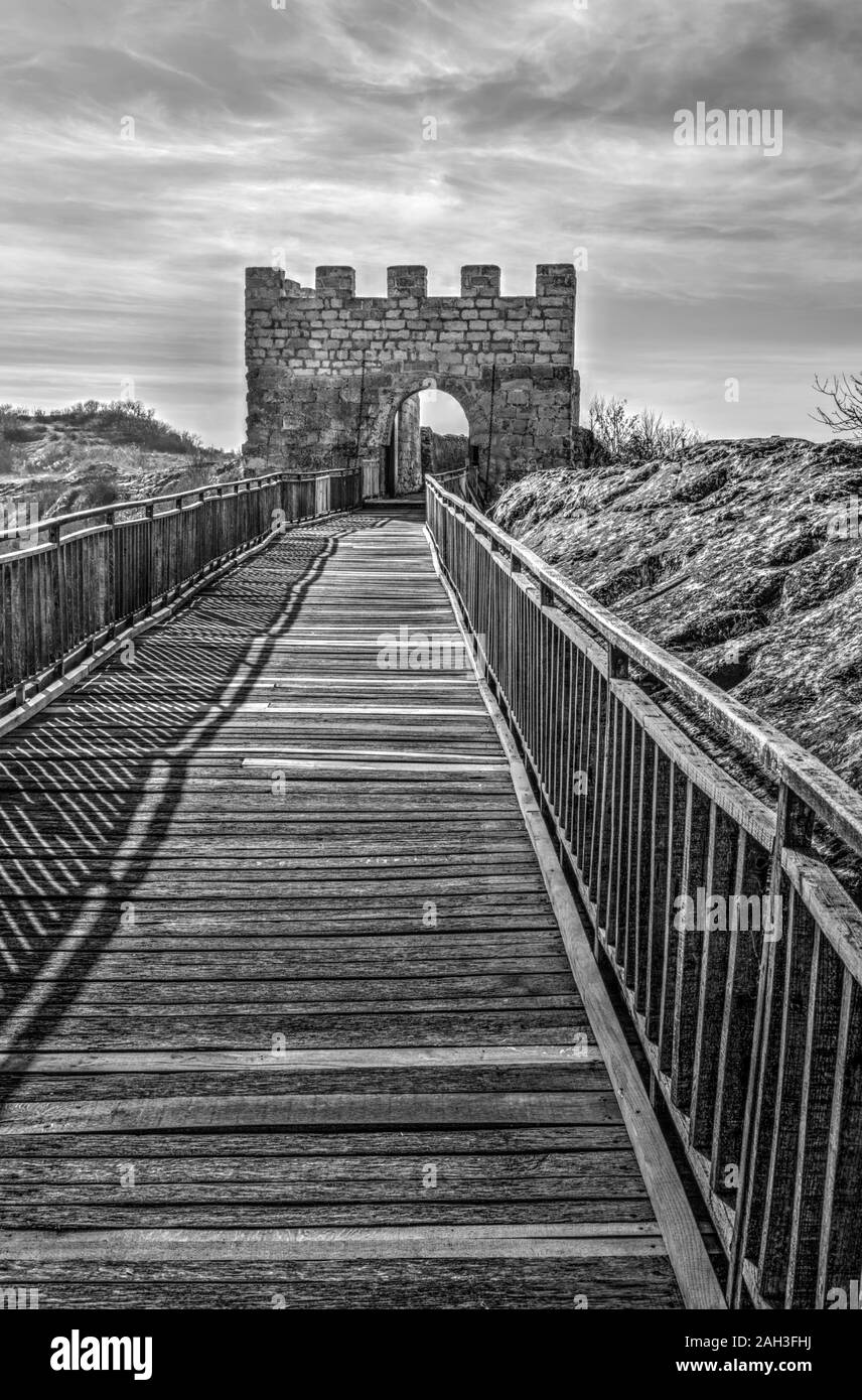 Beautiful view with wooden bridge and stone gate of an ancient fortress ...