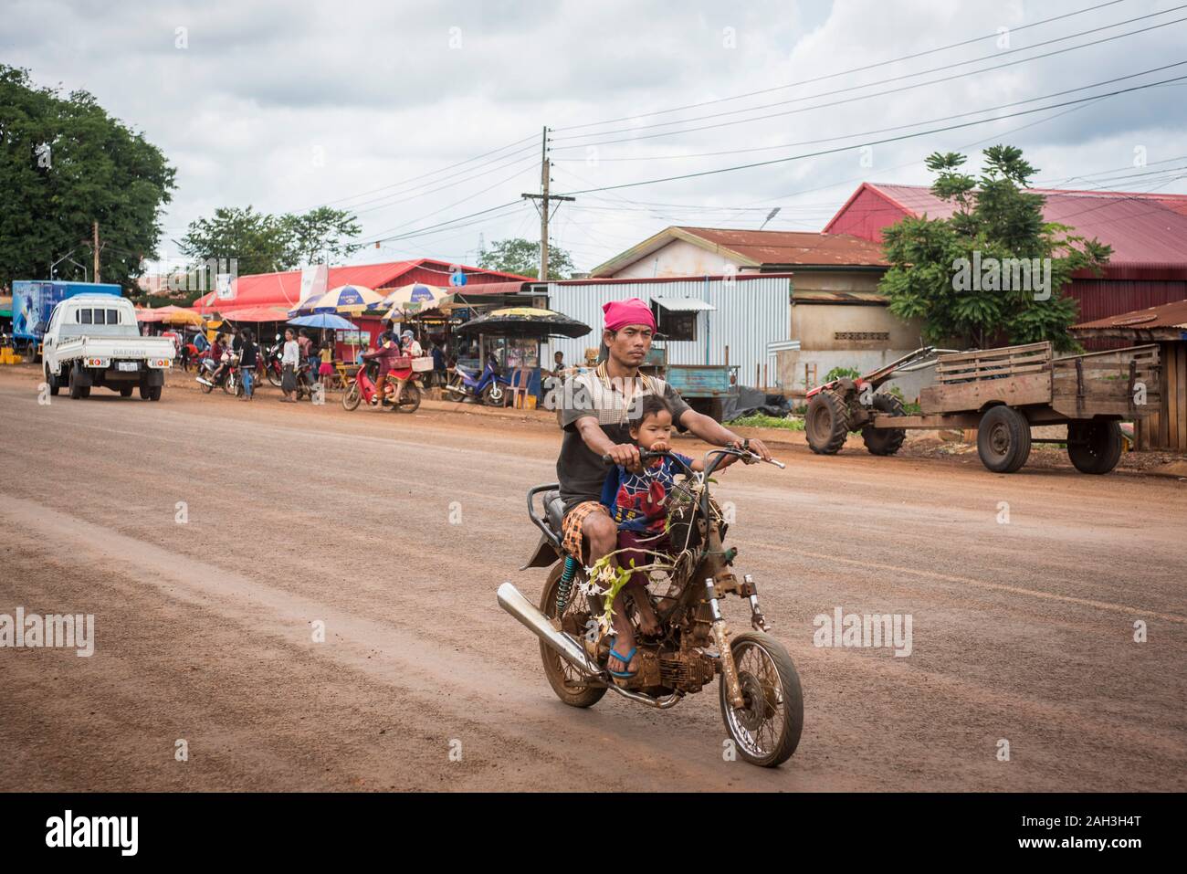 Laongam, Laos, father and son on motorcycle Stock Photo