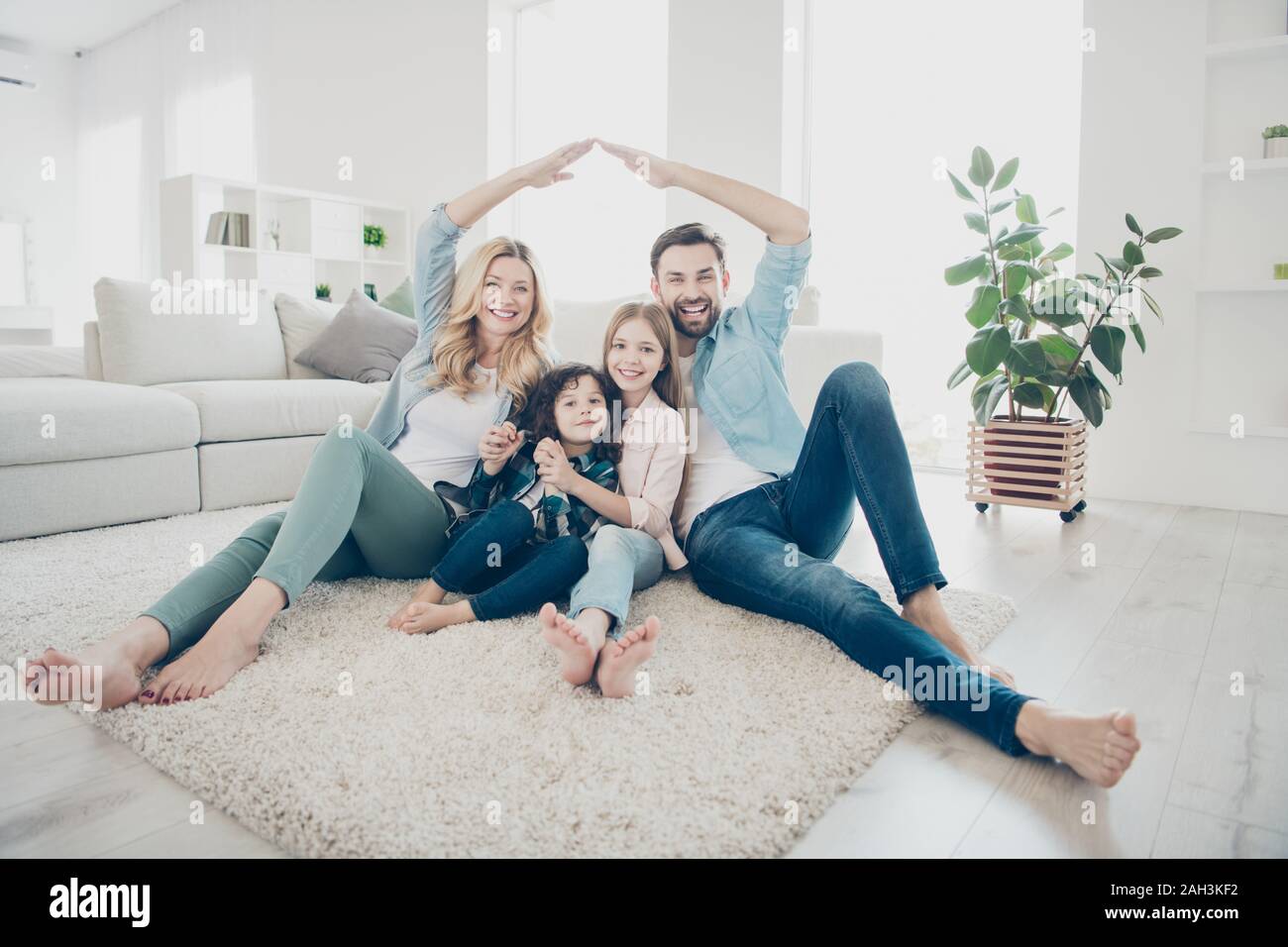 Photo of four people foster family moving new apartments making arms