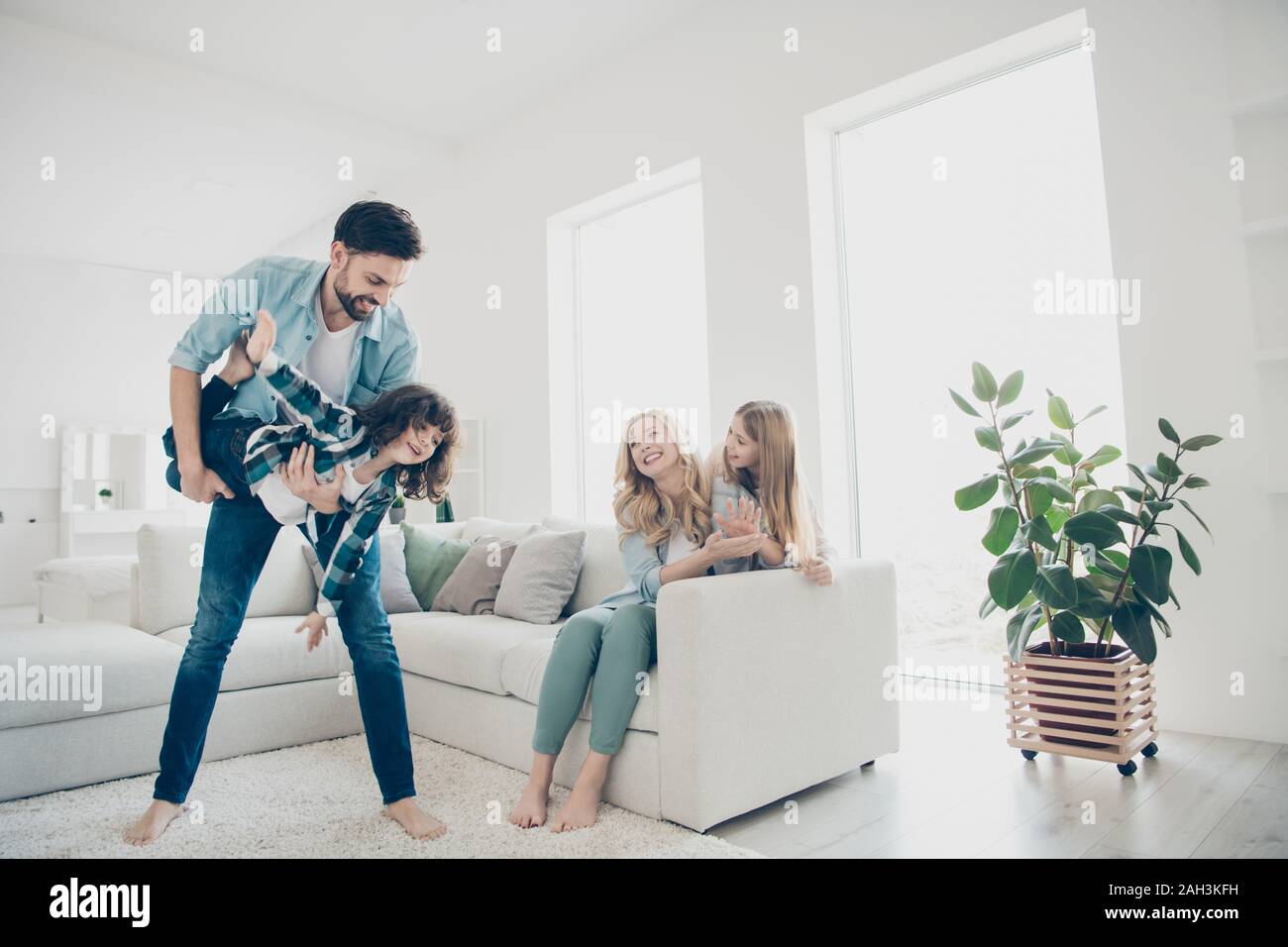 Photo of four people foster family moving like airplane with help parents hands cozy apartments