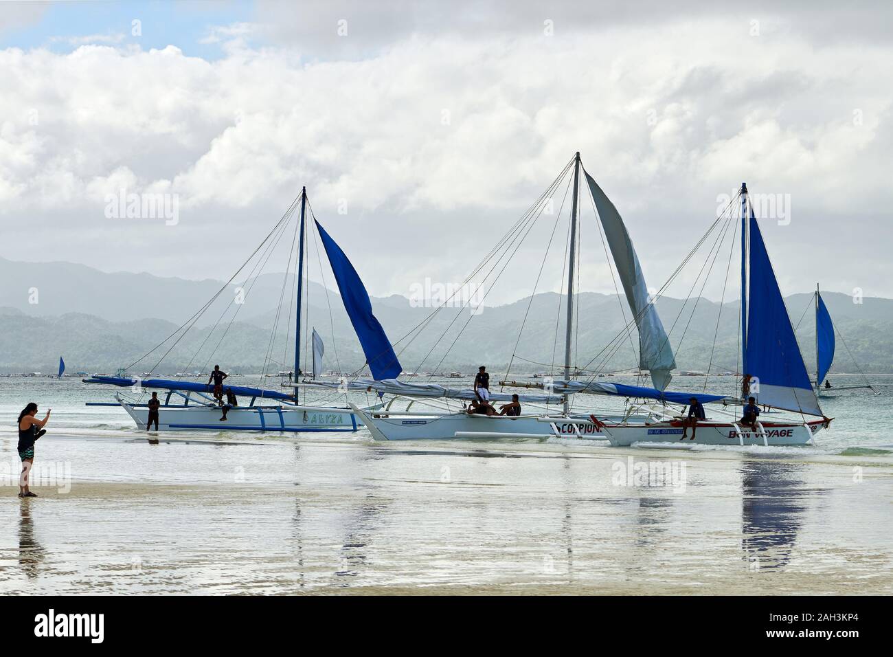 Boracay, Aklan Province, Philippines - January 3, 2019: Sailboats parking along the White Beach with sails down because of bad weather conditions Stock Photo