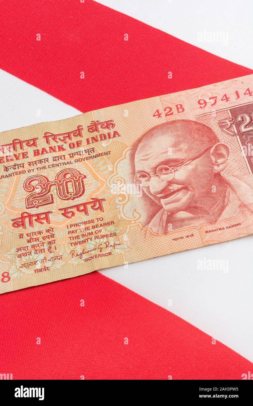 Old style Indian 20 Rupee banknotes / bill & Union Jack. For India Rupee exchange rate, India economy, India UK exports, India UK balance of payments. Stock Photo