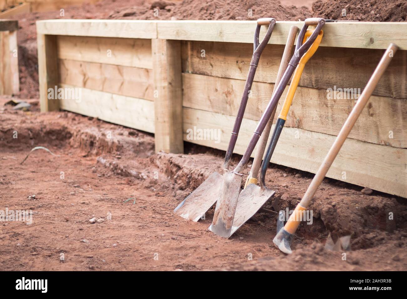 Landscape gardening work tools and retaining wall Stock Photo