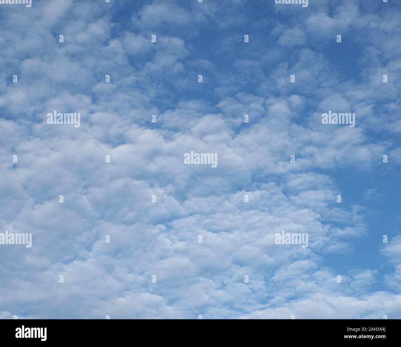 blue sky with clouds useful as a background Stock Photo - Alamy