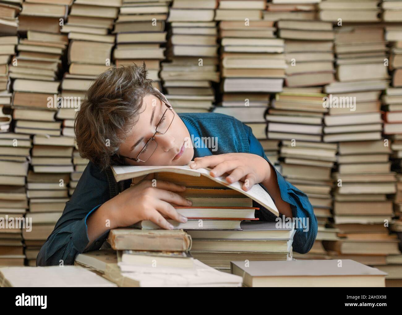 Tired young boy and books. Tired young boy sitting and sleeping ...