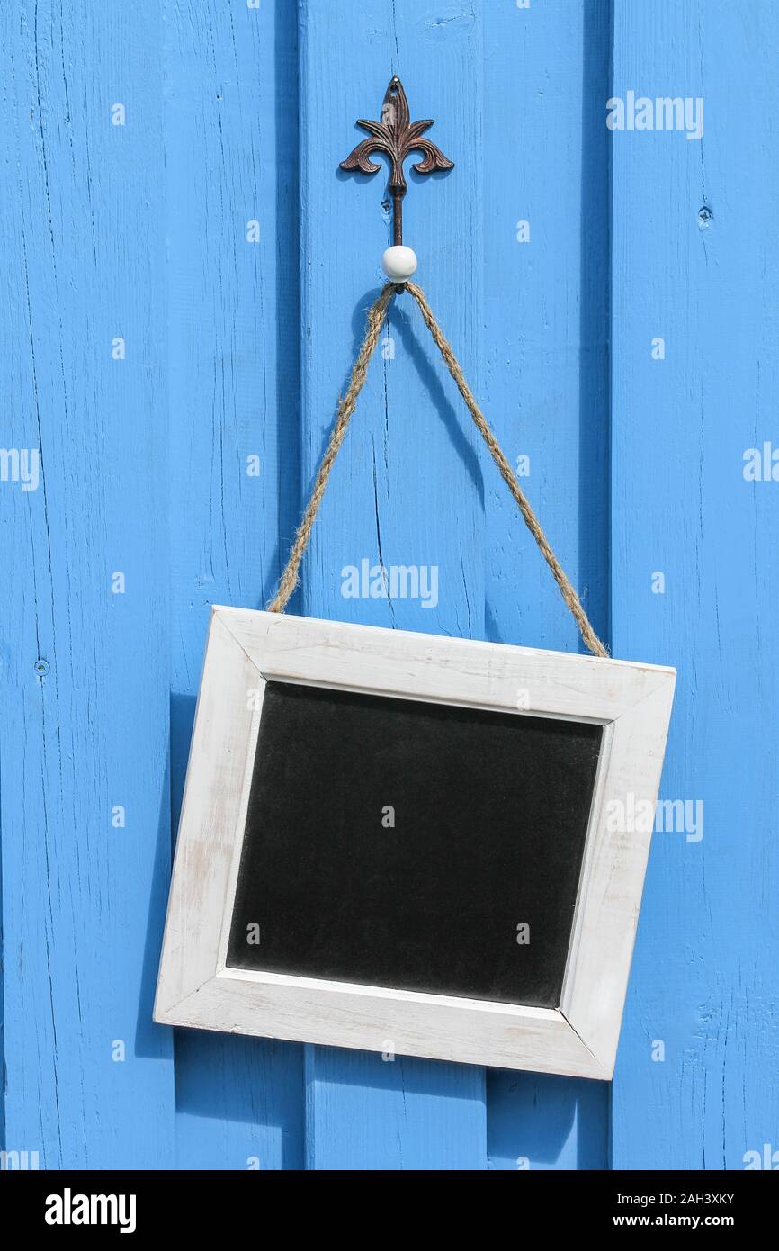 Blackboard on a blue summerhouse Stock Photo