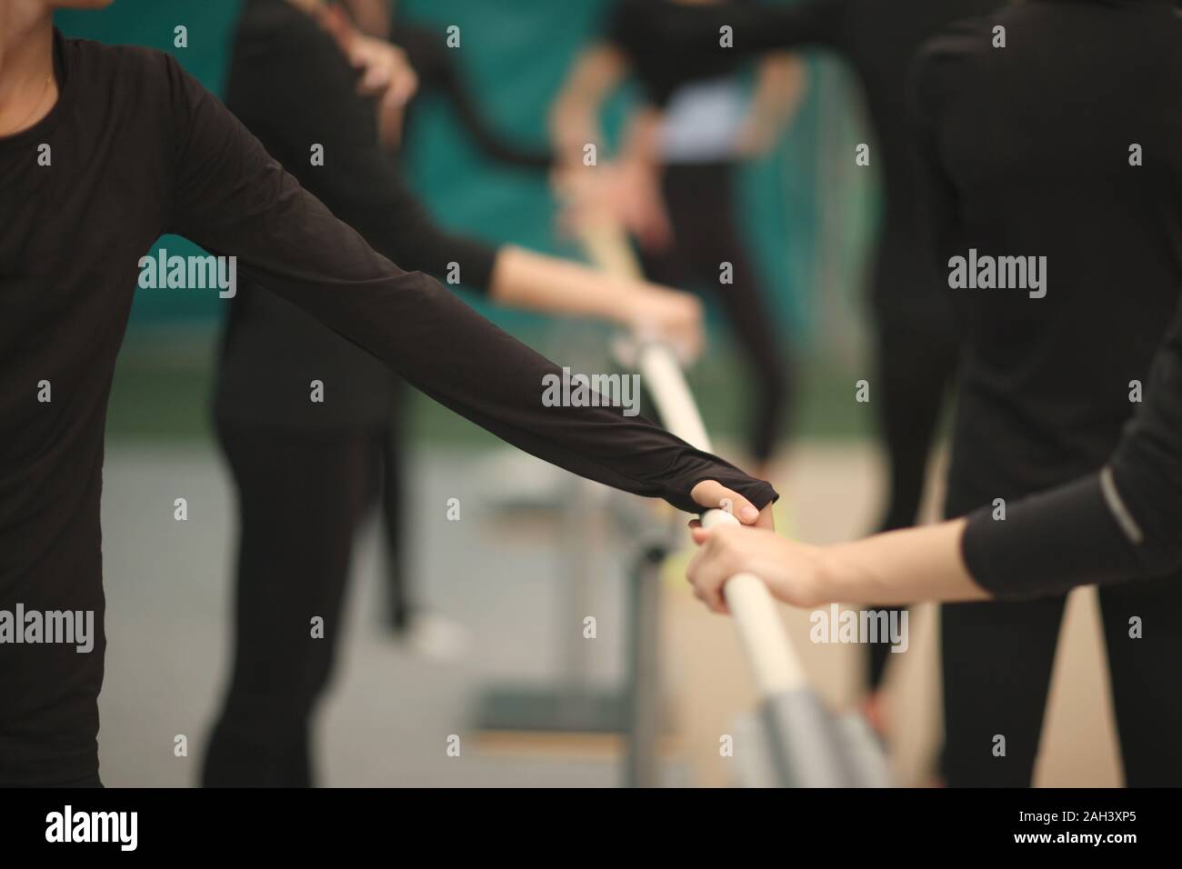 Hands of sportswomen on the choreographic handrail in the rehearsal ...