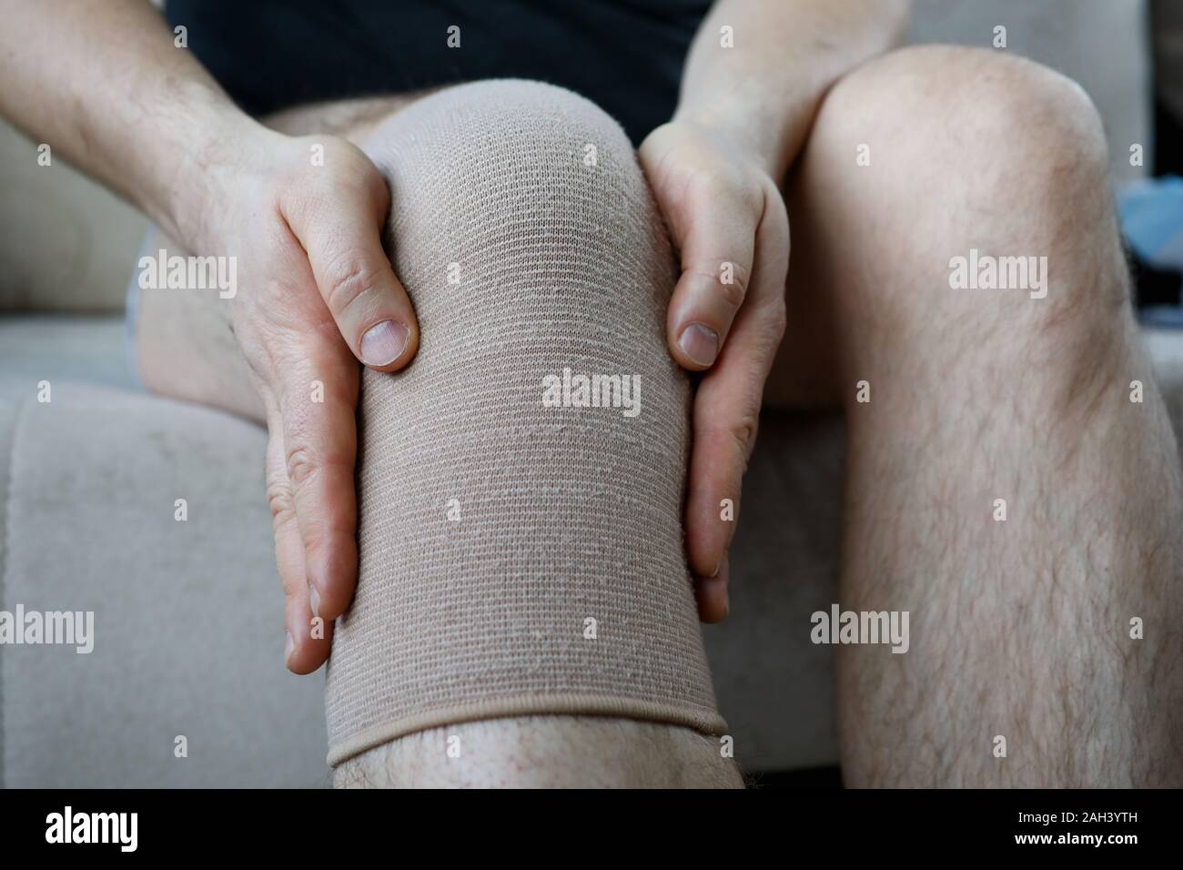 Male hands hold by the knee. Meniscus joint pain is a problem