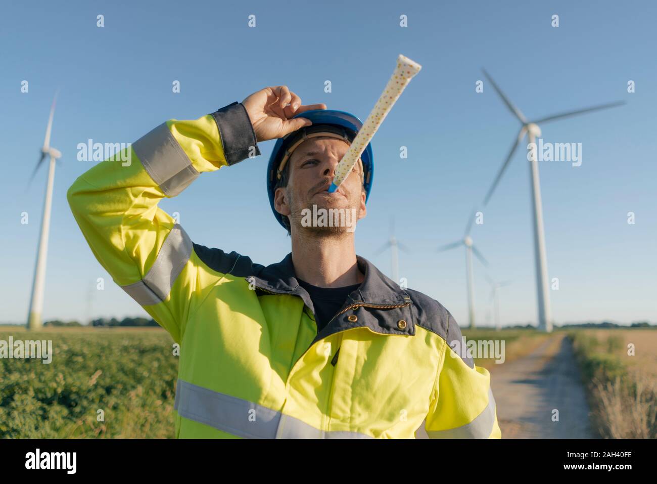 Portrait of an engineer with party blower at a wind farm Stock Photo