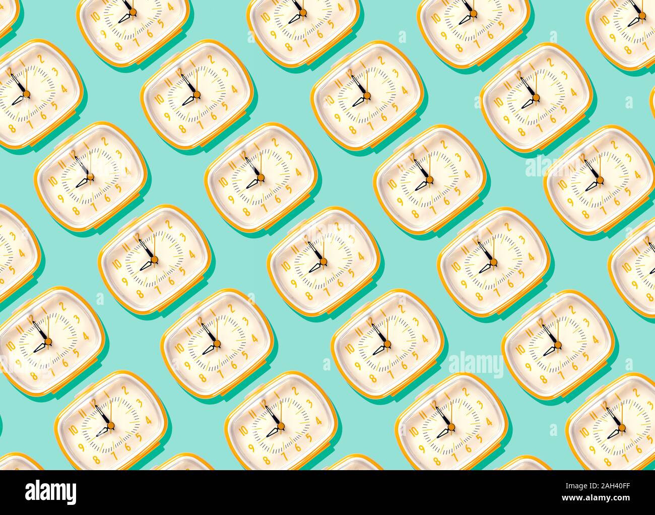 3D Illustration, row of yellow alarm clocks at nine o'clock pattern on turquoise background Stock Photo