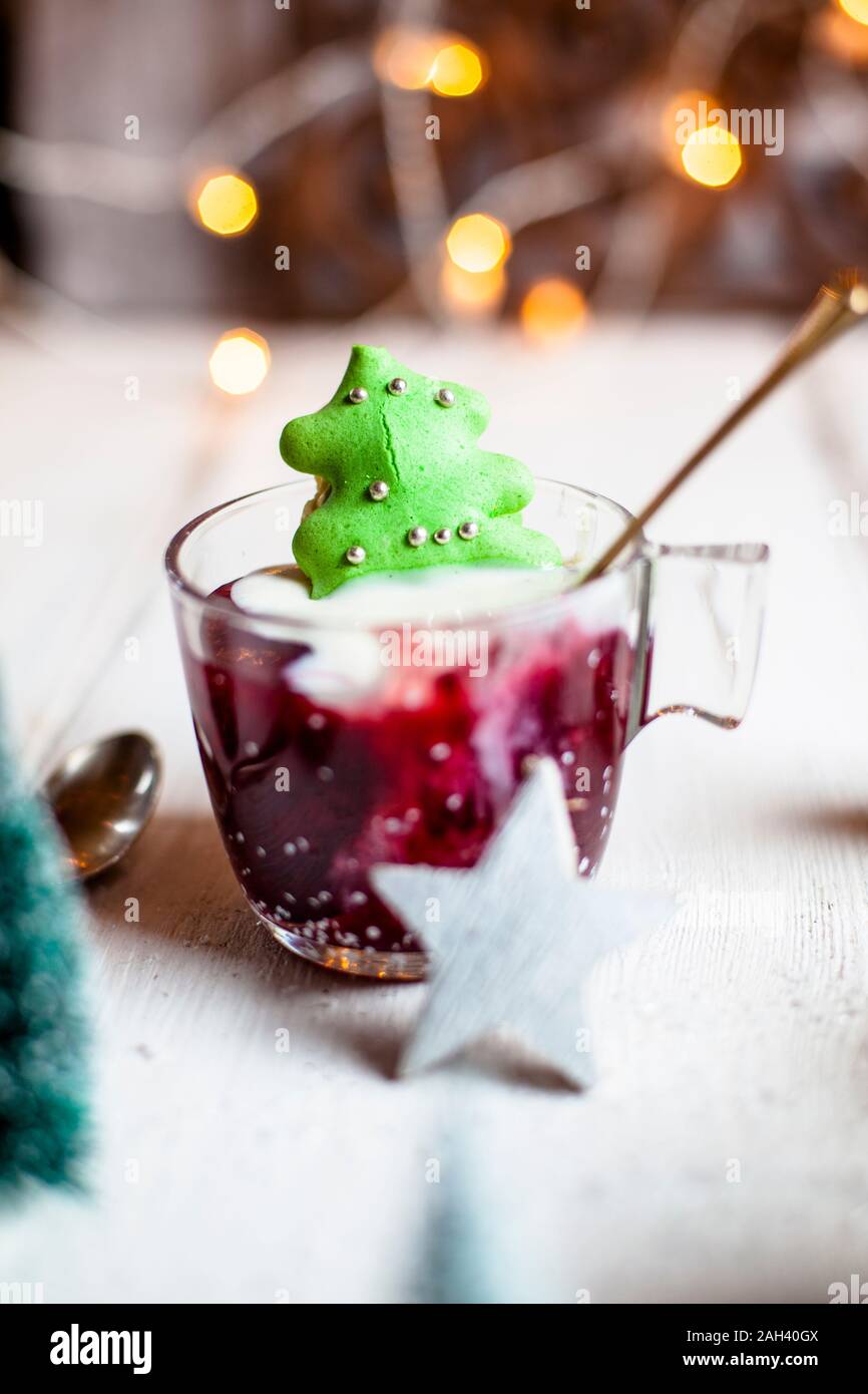 Cup of red porridge with green macaroon Christmas tree Stock Photo